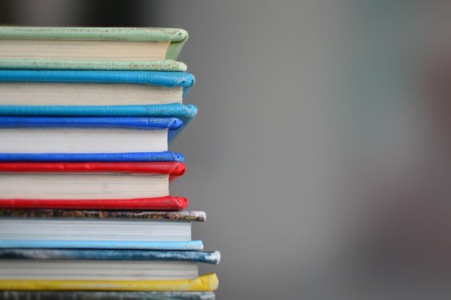 Academic books piled up reflecting knowledge